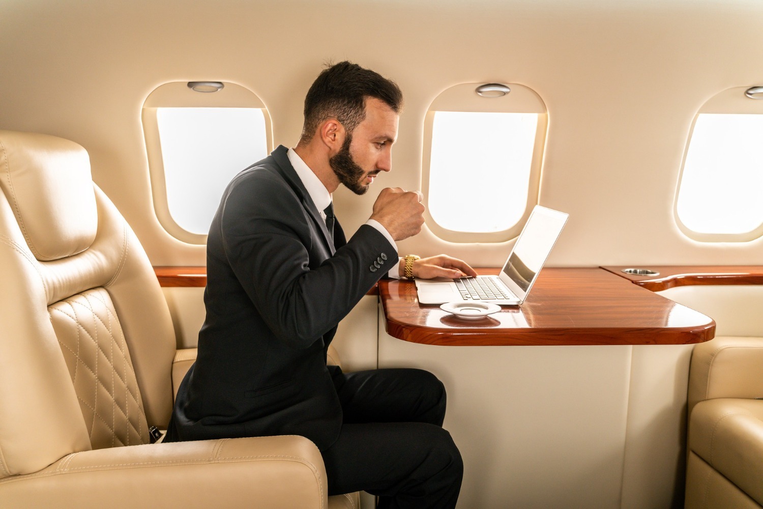 handsome-businessman-wearing-elegant-suit-flying-exclusive-private-jet.jpg
